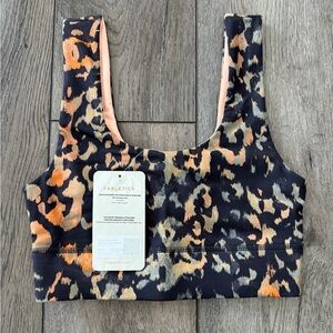 Fabletics Women's Harlow Reversible Medium Impact Sports Bra, Wild Camo/Gaia